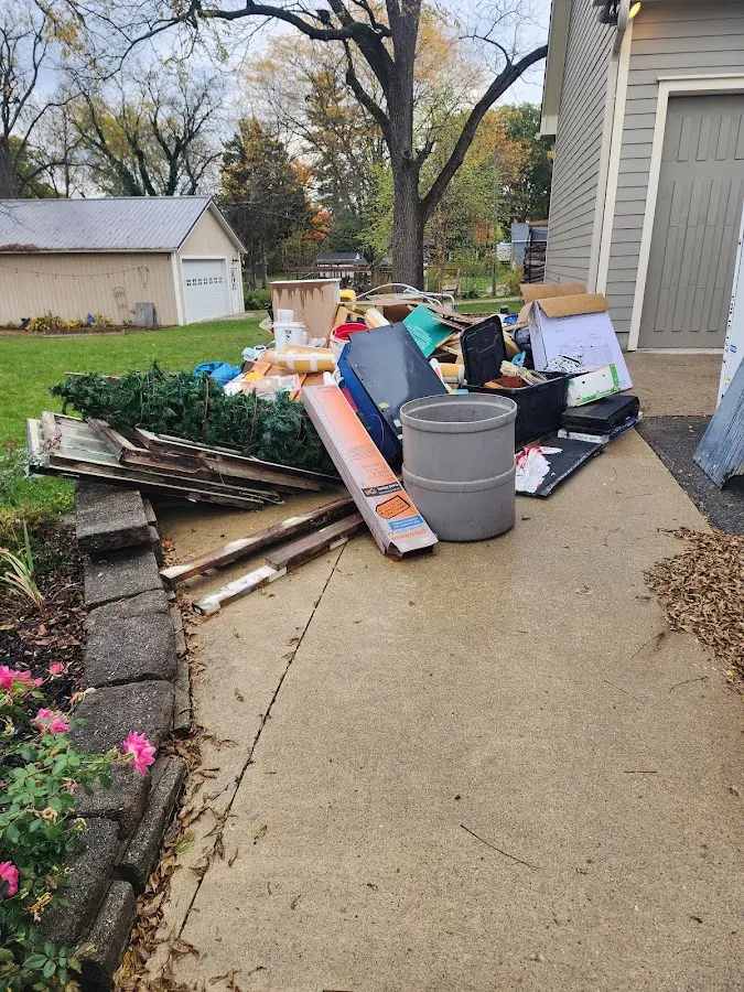 Dumpster being loaded with debris for Estate Cleanout Dumpster Rental in McPherson